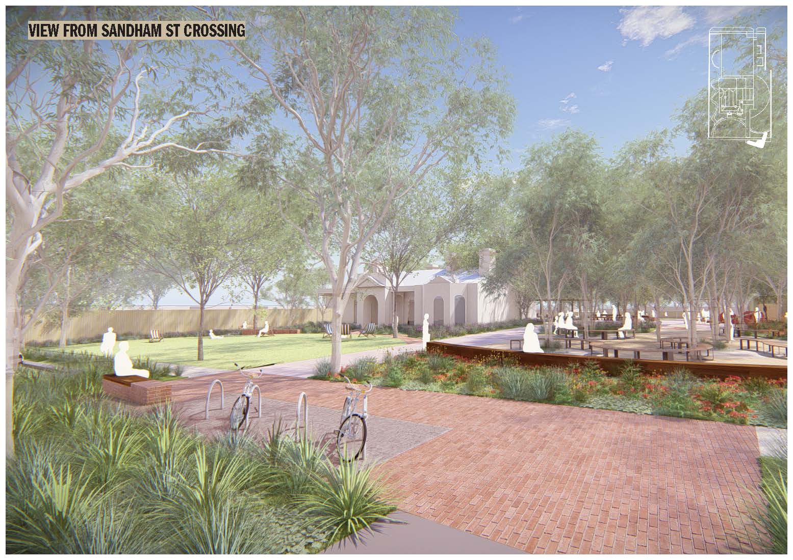 Ground-level view from Sandham Street, looking into the precinct. The foreground features bike racks, garden beds, and paved paths leading towards the heritage building, with mature trees providing shade and seating areas visible.